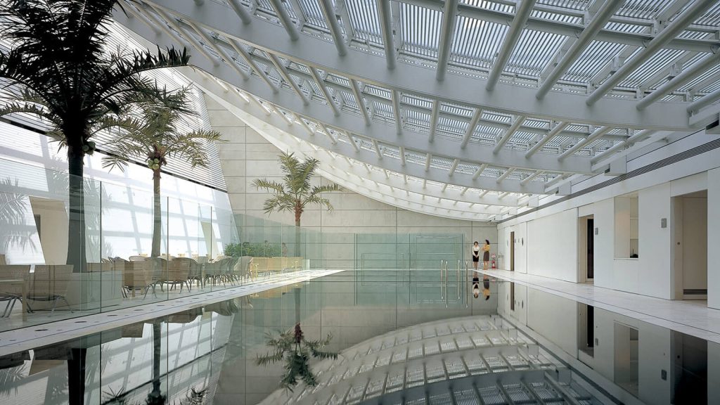 Swimming pool interacting with natural light and skylight above