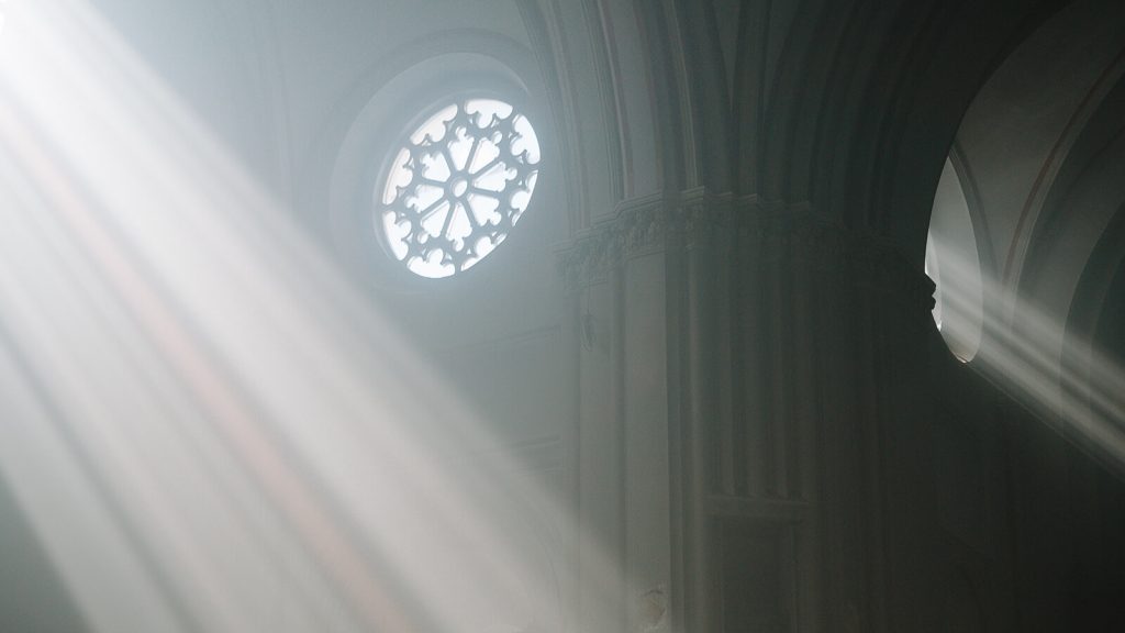 Light from the outside flowing into the church through windows