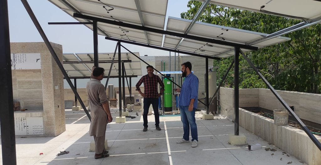 Solar panels and roof circulation discussion on site visit by Architects of Primarc Studio in Islamabad