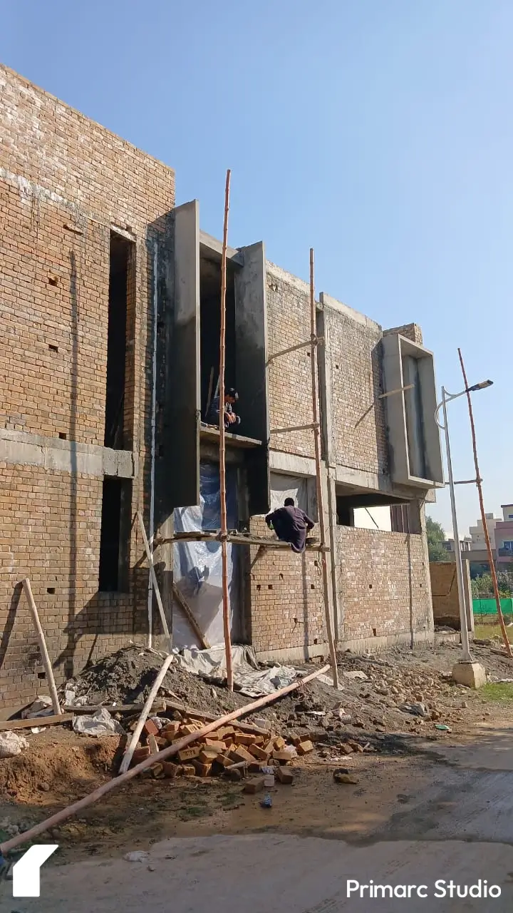 Under-construction 7 marla house in B-17, Sector C, Islamabad, with visible progress on roofing and wall plastering work.