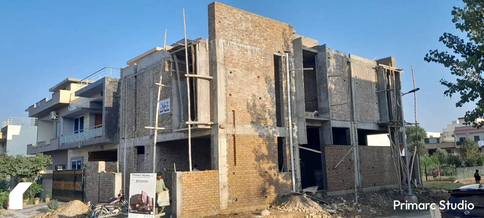 Side view of a 7 marla under-construction house in B-17, Sector C, Islamabad, highlighting brickwork and ongoing construction details.