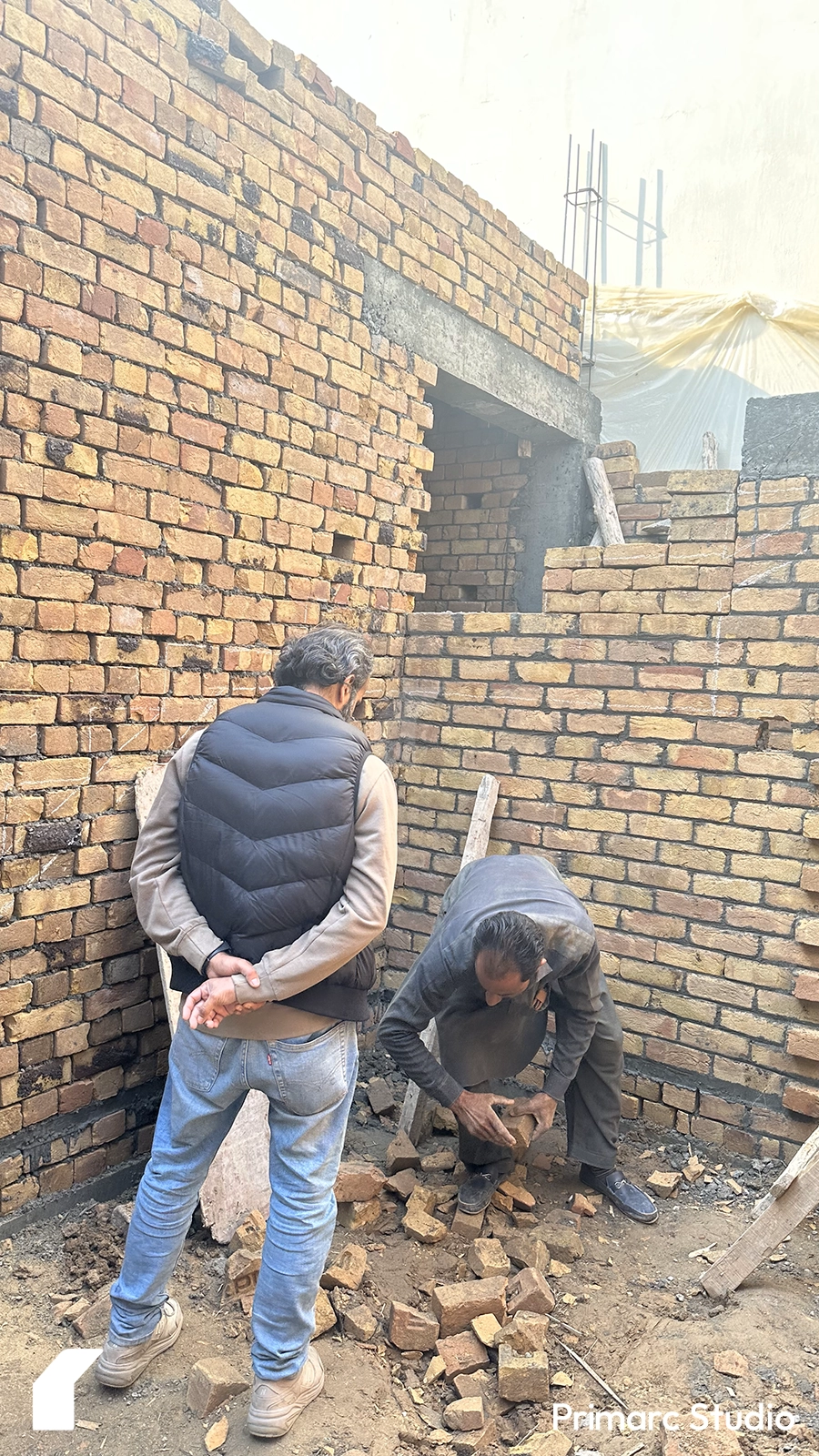 Architect viewing the labour work during the construction of house in gulberg greens.