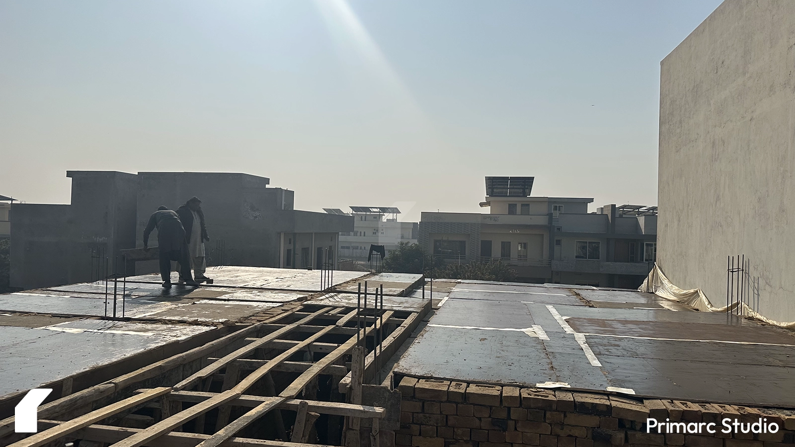 Workers working on the shuttering of the house