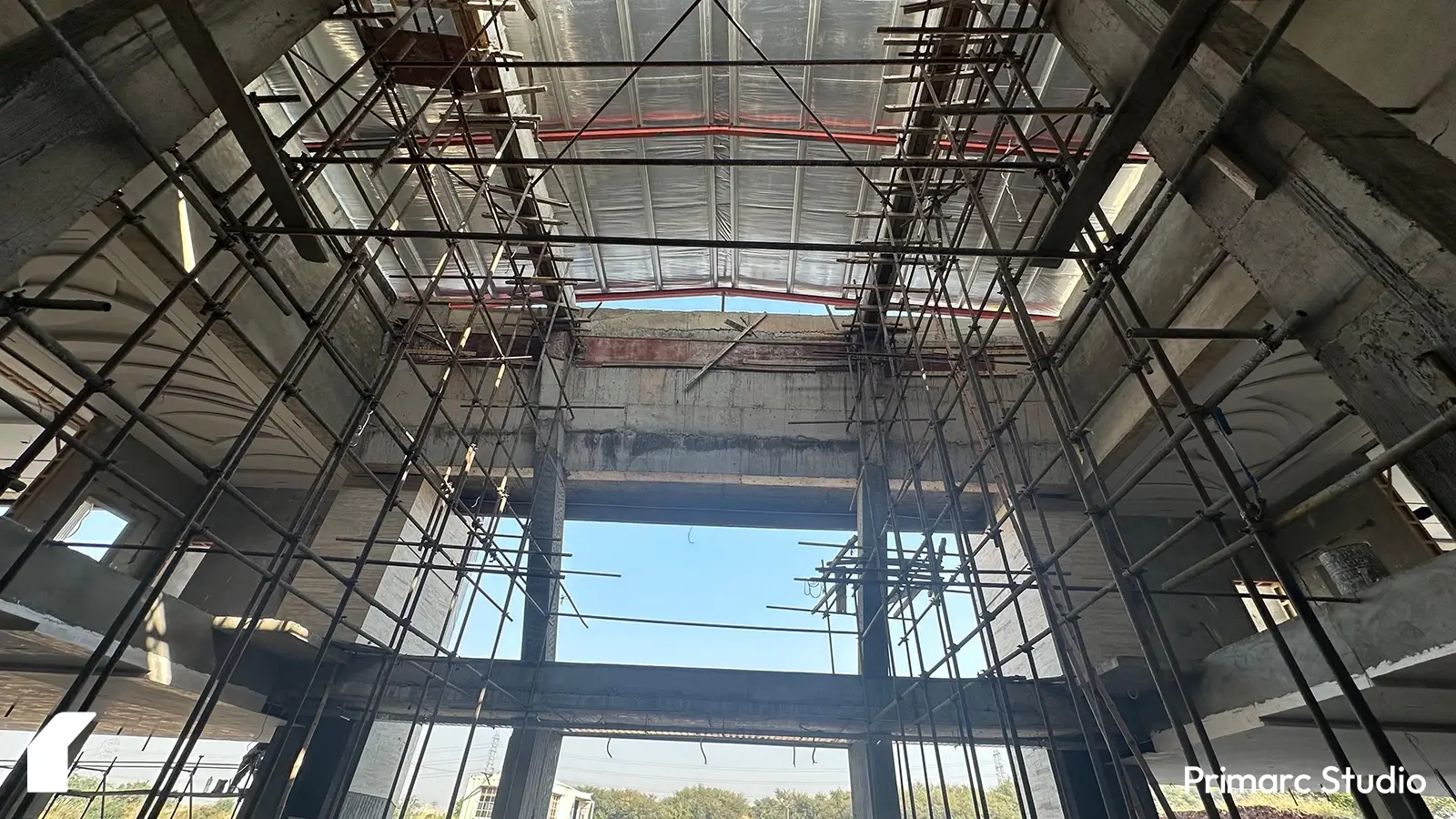 Scaffoldings set up inside the modern marquee in Islamabad, marking the beginning of interior work. The space showcases the early stages of construction, emphasizing the scale and contemporary design of the venue.