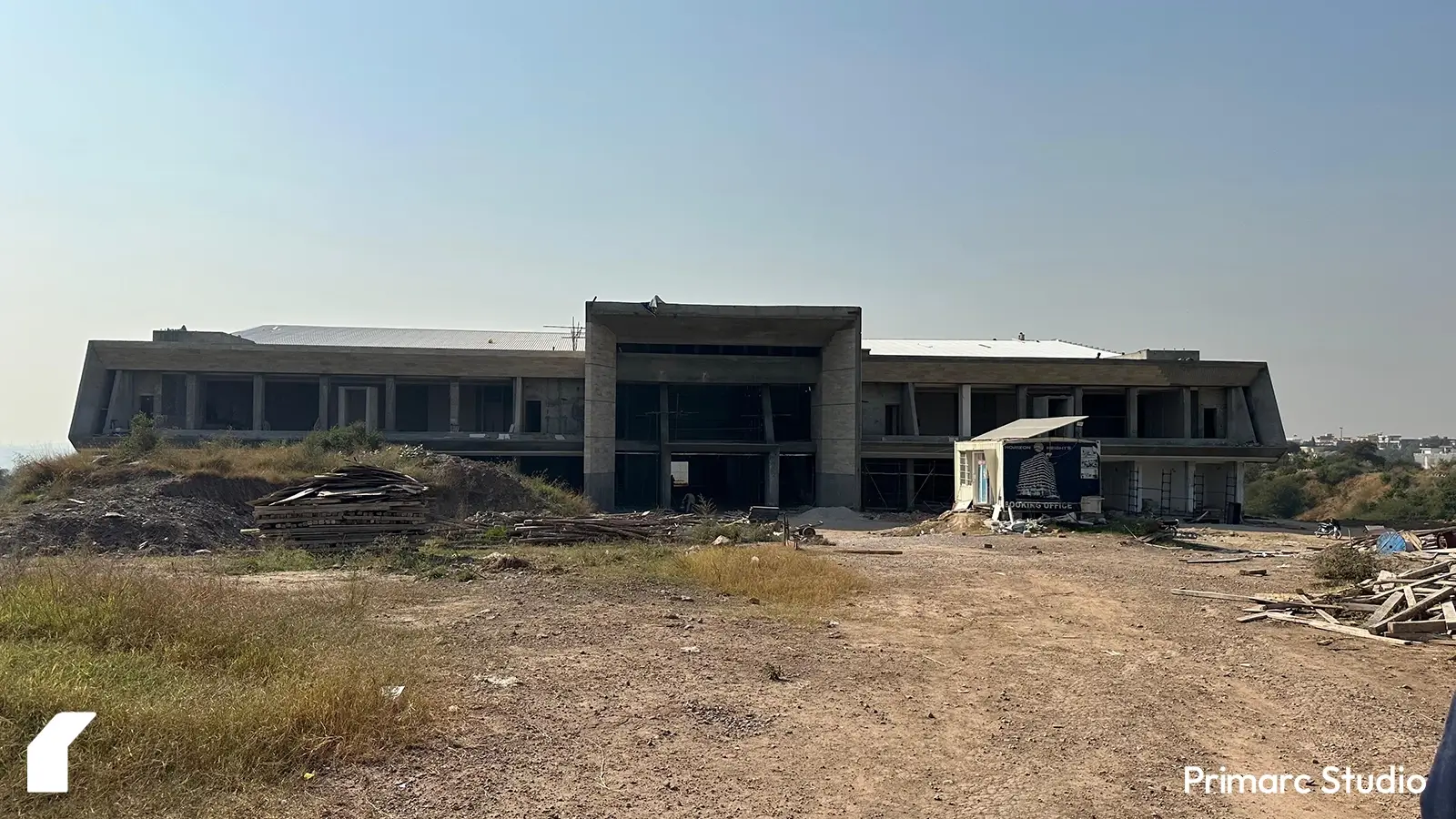 Facade of a modern marquee in Islamabad with laborers applying travertine cladding. The design highlights a contemporary architectural style with premium travertine finish, enhancing the marquee's elegant appearance.