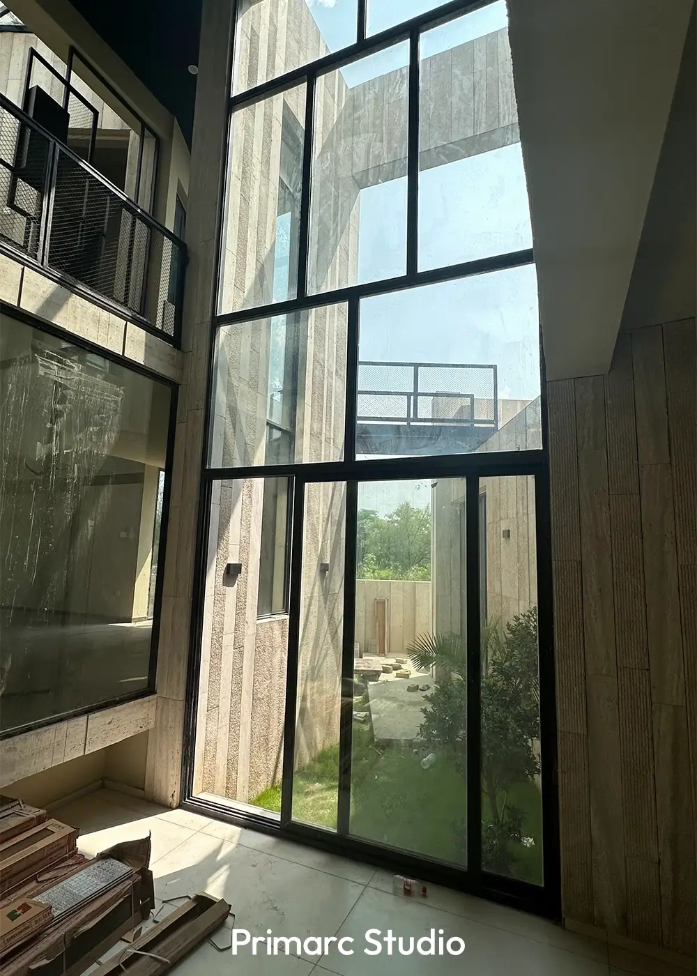 Interior view highlighting the large windows providing ample natural light in the contemporary 1 kanal residence in Islamabad, showcasing the integration of the outdoors with the unique modern architecture.