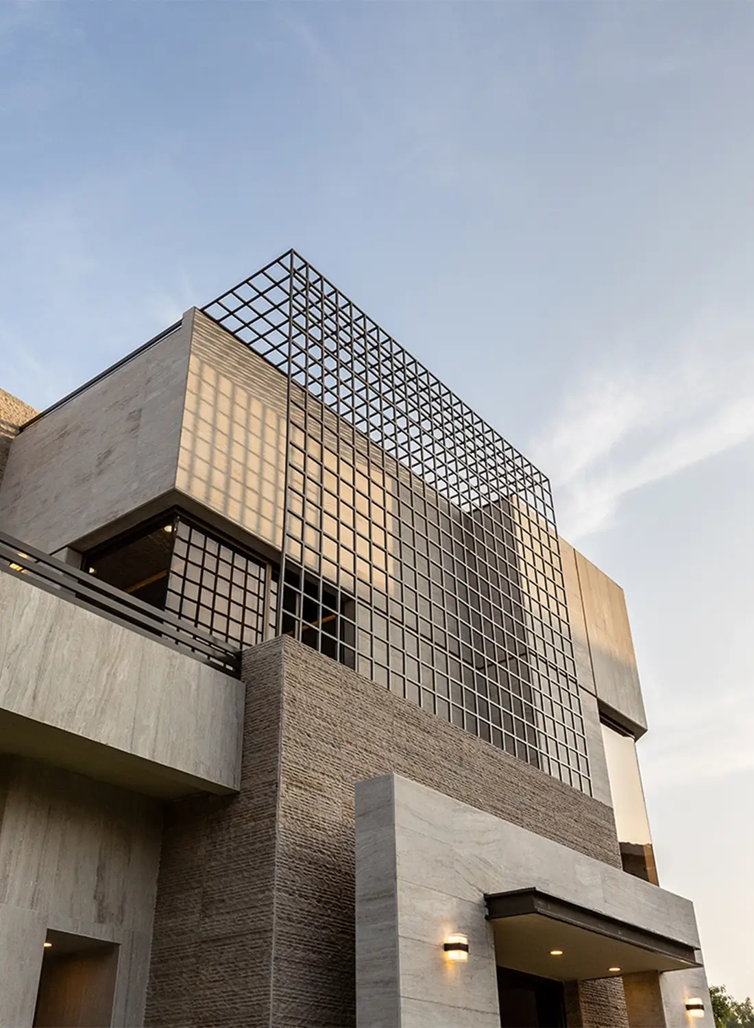 Exterior view of a luxury modern corner house in DHA Phase 2, Islamabad, showcasing the renovated facade design by Primarc Studio for enhanced external aesthetics and modern living.