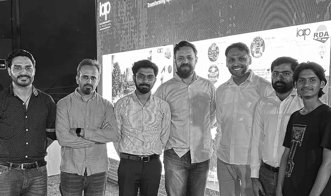 A team of architects stands proudly in front of a backdrop that reads "ECHOES OF RAWALPINDI Urban Monument Design Challenge - Transforming Space-Sculpting Stories." Logos for IAP (Institute of Architects Pakistan) and RDA (Rawalpindi Development Authority) are visible.