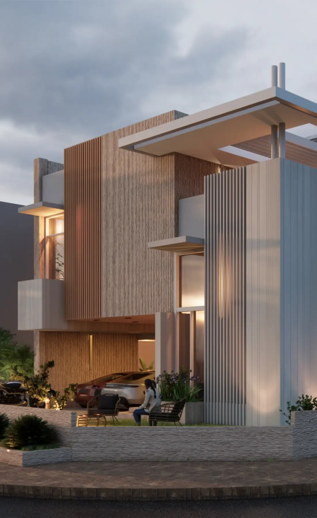 Bespoke residential architecture by Primarc Studio. The image shows the modern exterior of Tahir House at dusk, with warm lighting illuminating its interlocking volumes of wood and fluted white panels.