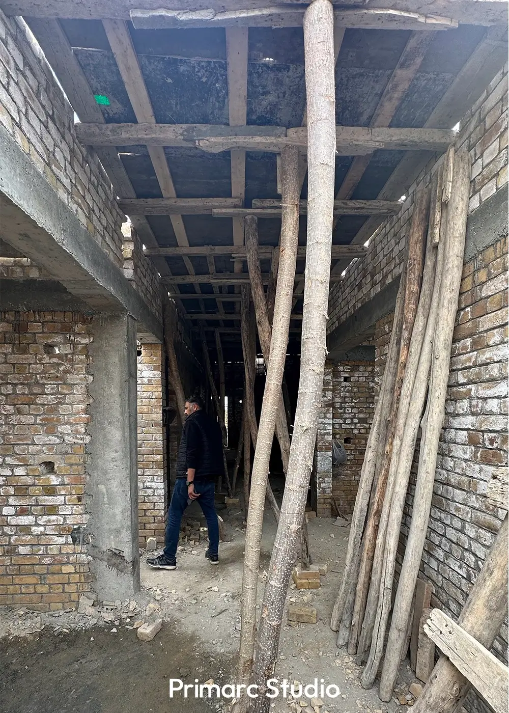 An inside look at the construction, showing the wooden support beams and columns holding up the new ceiling of the house in F-11, Islamabad.