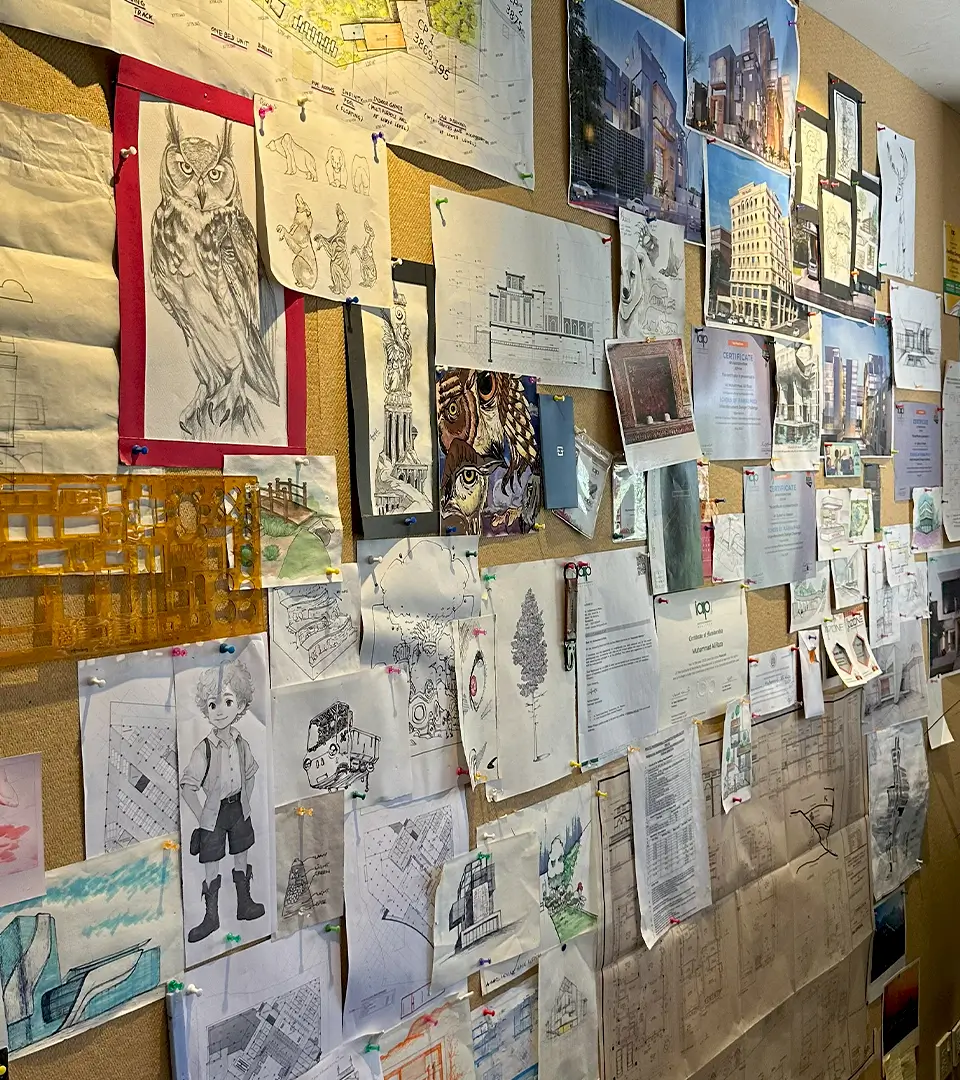 The inspiration wall at Primarc Studio, covered in architectural sketches, project renderings, and drawings, showcasing the creative environment and design process central to our careers.