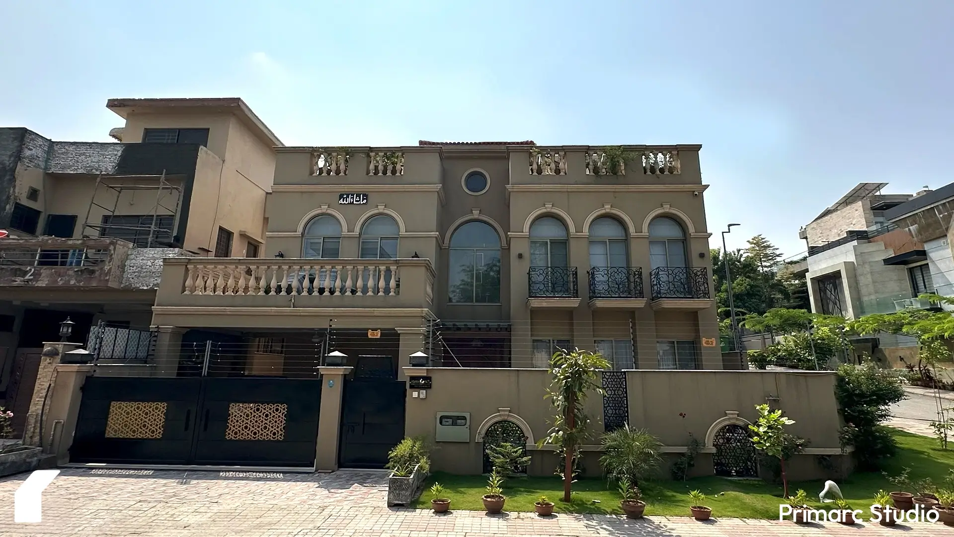 Full front elevation of Noman House, a 1 kanal classical house in DHA Phase 2 Islamabad, featuring arched windows, balconies, and landscaped lawn.