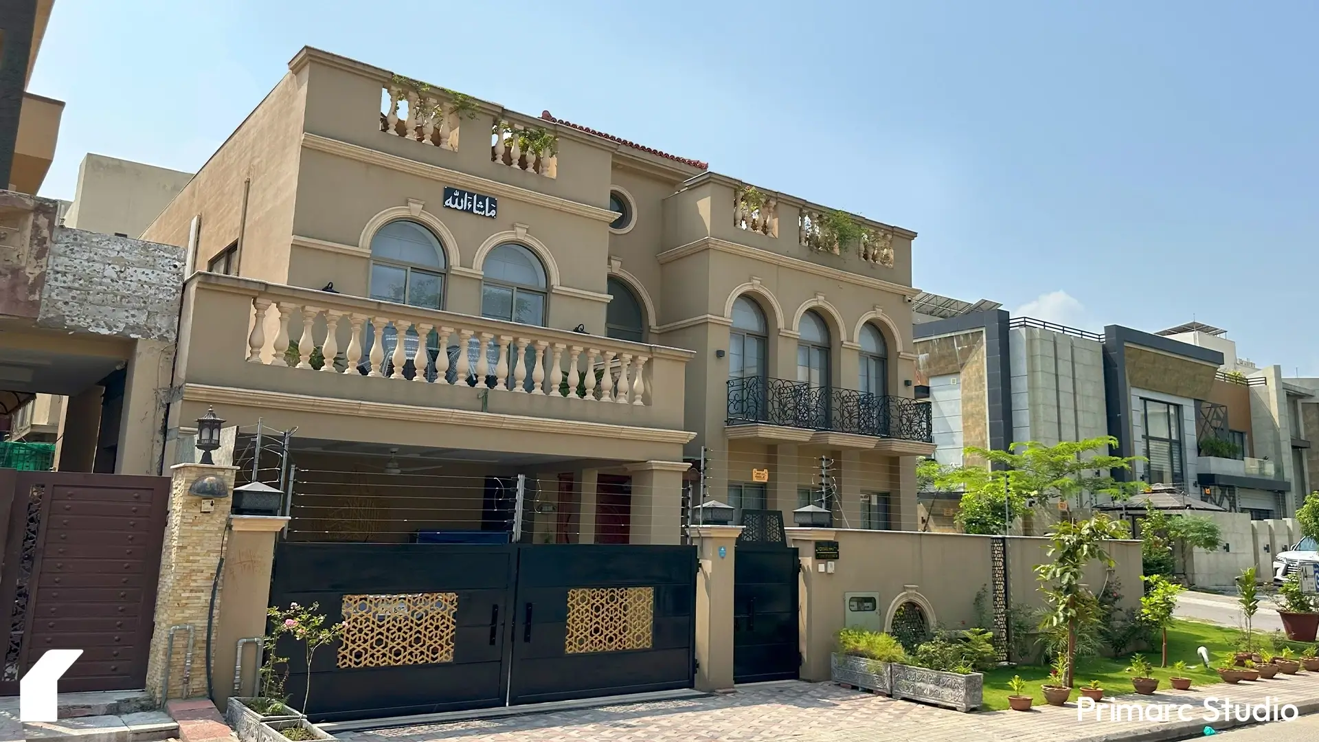 Angled street view of Noman House, a 1 kanal classical house in DHA Phase 2 Islamabad, with arched balconies, wrought iron railings, and decorative façade.