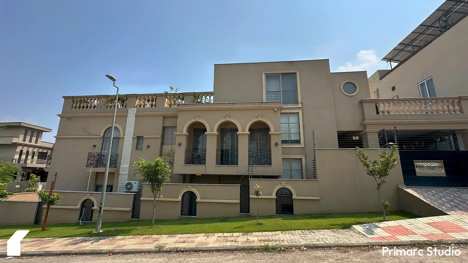 Side view of Noman House, a 1 kanal classical residence in DHA Phase 2 Islamabad, showing arched balconies, circular window, and boundary wall design.