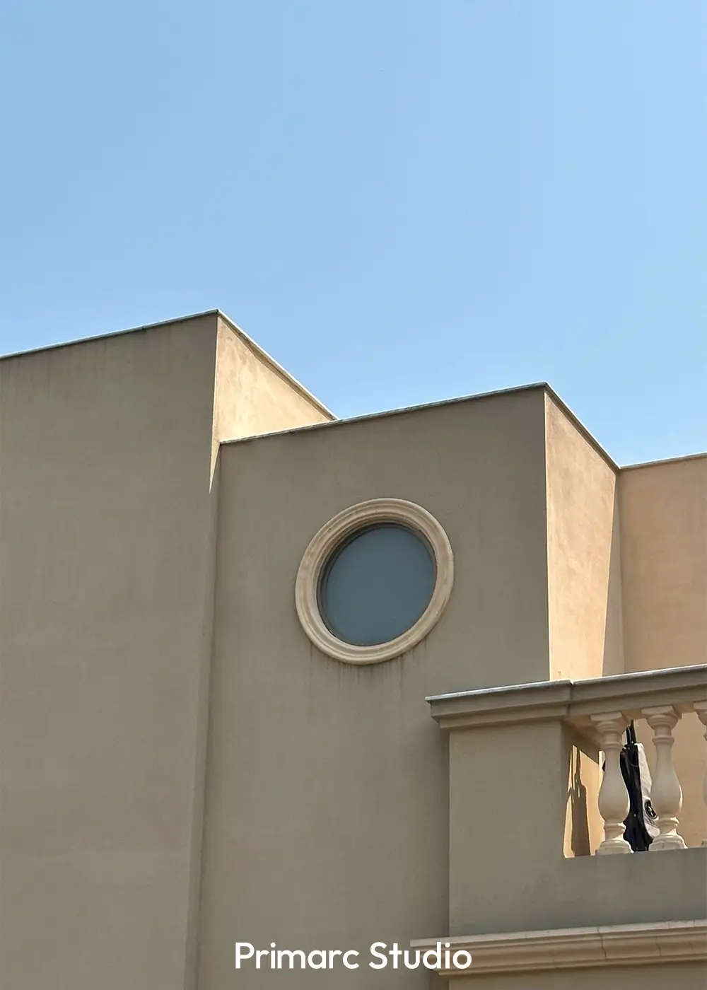 Detailed view of the façade of Noman House in DHA Phase 2 Islamabad, a 1 kanal classical house featuring symmetrical arched balconies and lush greenery.