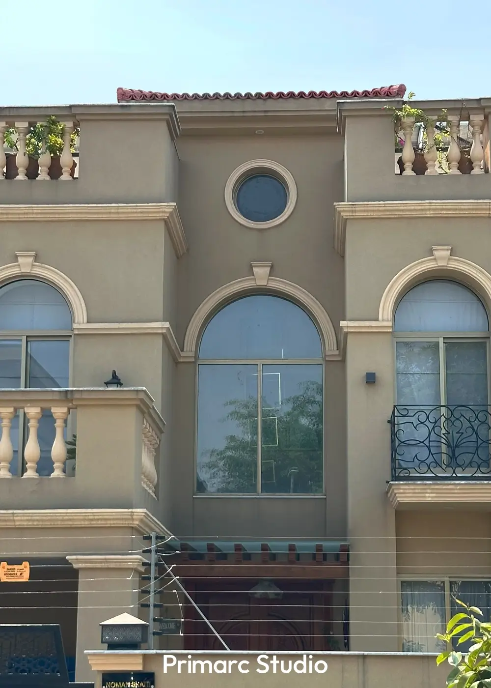 Upper terrace section of Noman House, a 1 kanal classical residence in DHA Phase 2 Islamabad, with decorative balustrades and climbing greenery.