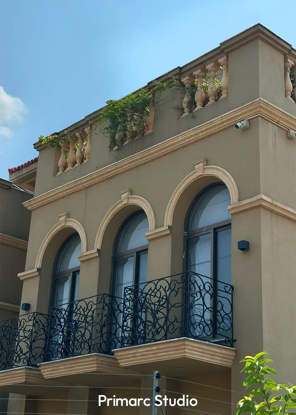 Close-up of balcony railing and arched window design at Noman House, a 1 kanal classical residence in DHA Phase 2 Islamabad.