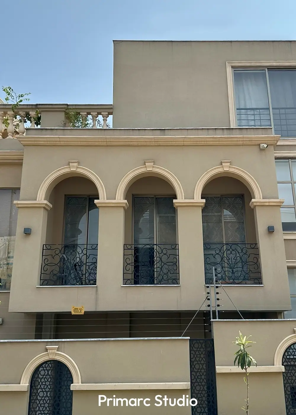 Upper floor balcony view of Noman House, a 1 kanal classical house in DHA Phase 2 Islamabad, with ornate arched windows and decorative railing.
