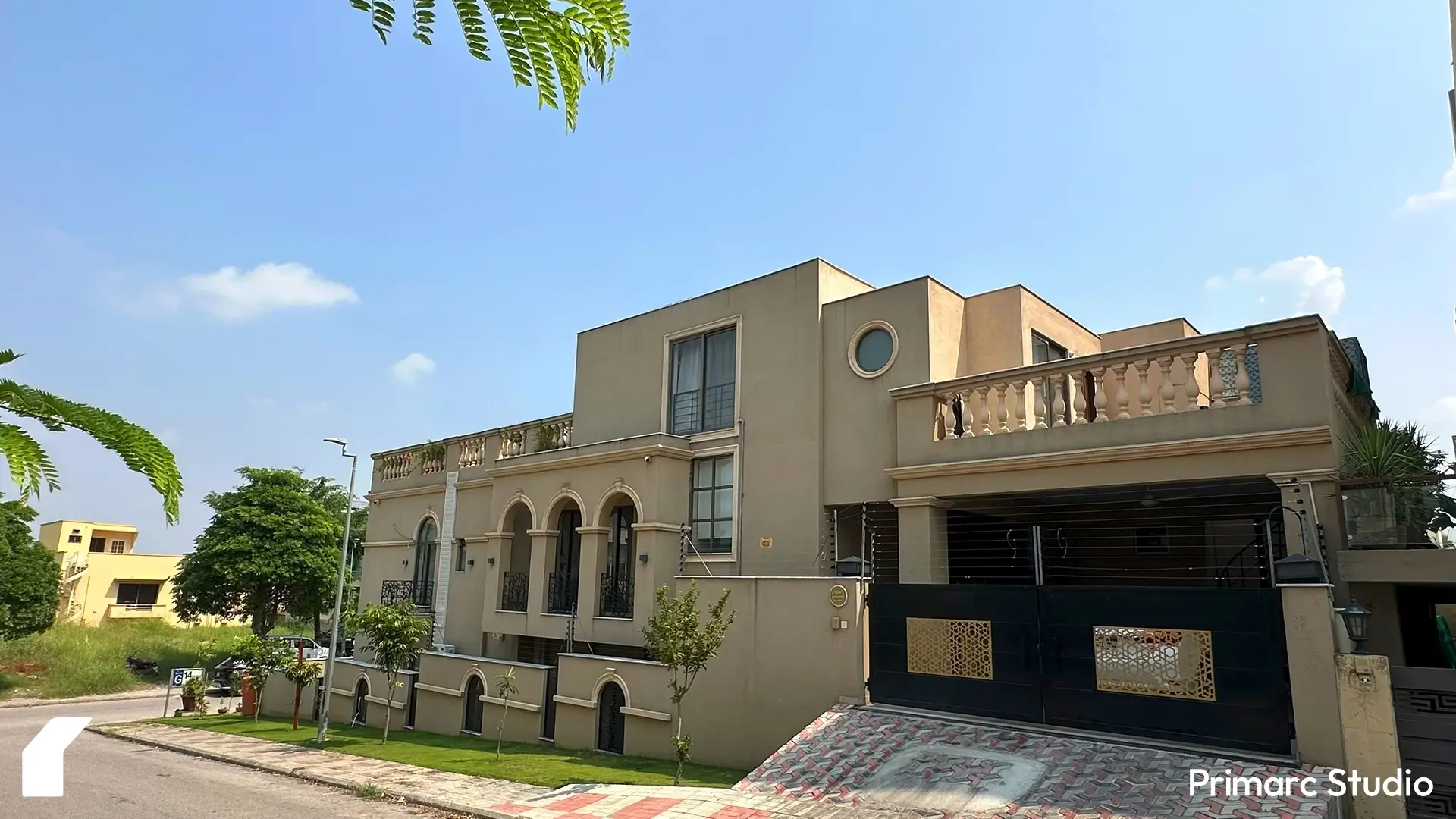 Side perspective of Noman House, a 1 kanal classical residence in DHA Phase 2 Islamabad, with arched balconies, circular window, and ornate boundary wall.