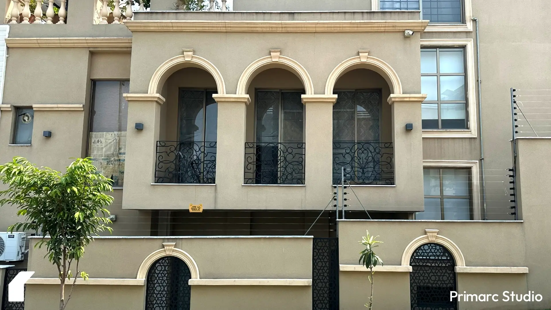 Detailed front view of Noman House, a 1 kanal classical house in DHA Phase 2 Islamabad, highlighting three arched balconies with wrought iron railings.