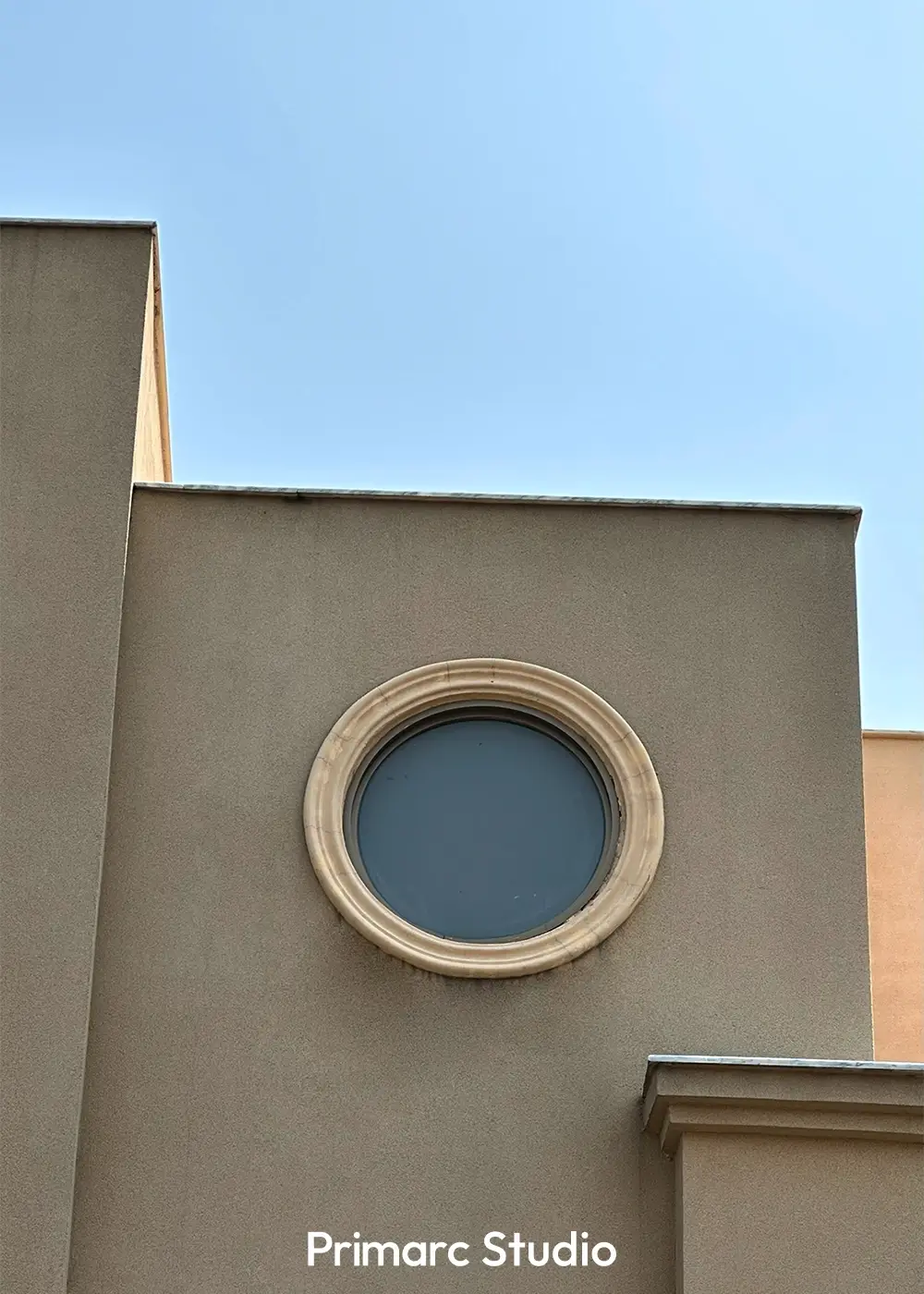 Close-up of circular accent window on the façade of Noman House, a 1 kanal classical residence in DHA Phase 2 Islamabad.