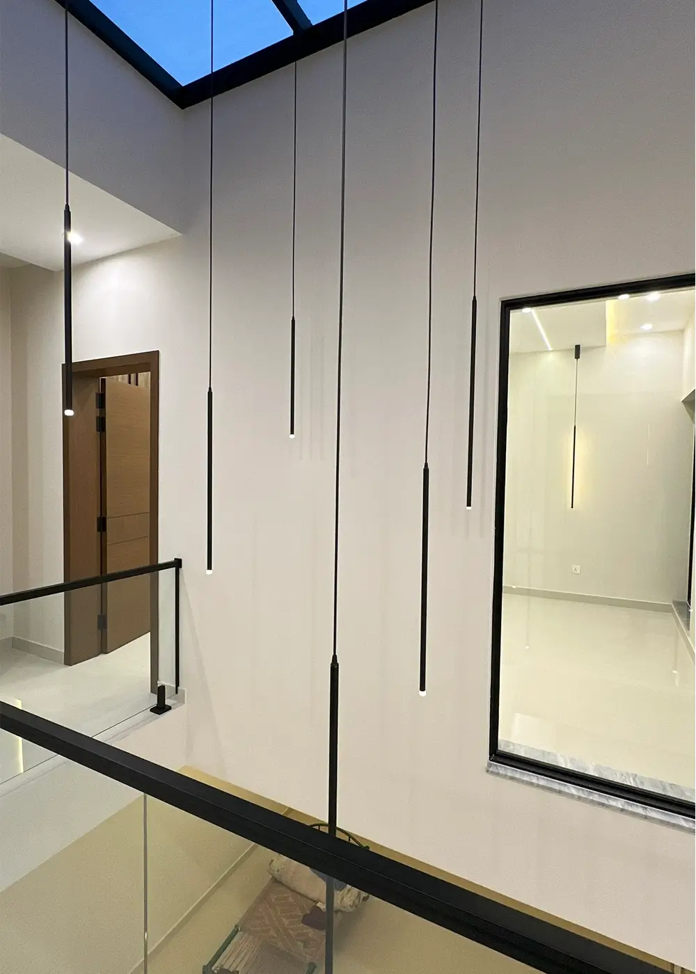 Hanging pendant lights under skylight in 10 marla modern house Gulberg Residencia Islamabad.
