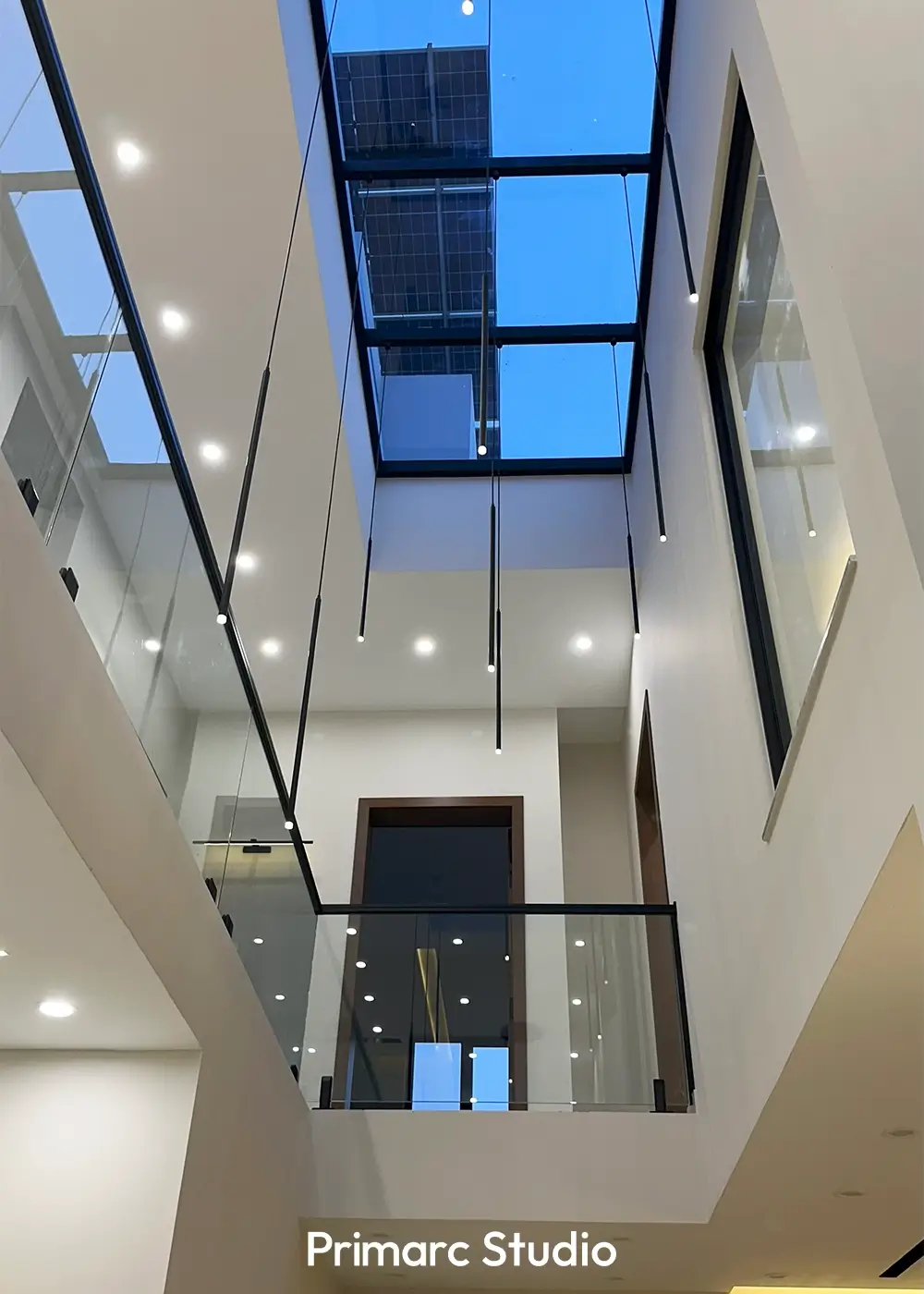 Atrium with skylight and pendant lights inside 10 marla house Gulberg Residencia Islamabad, designed for natural light and openness.