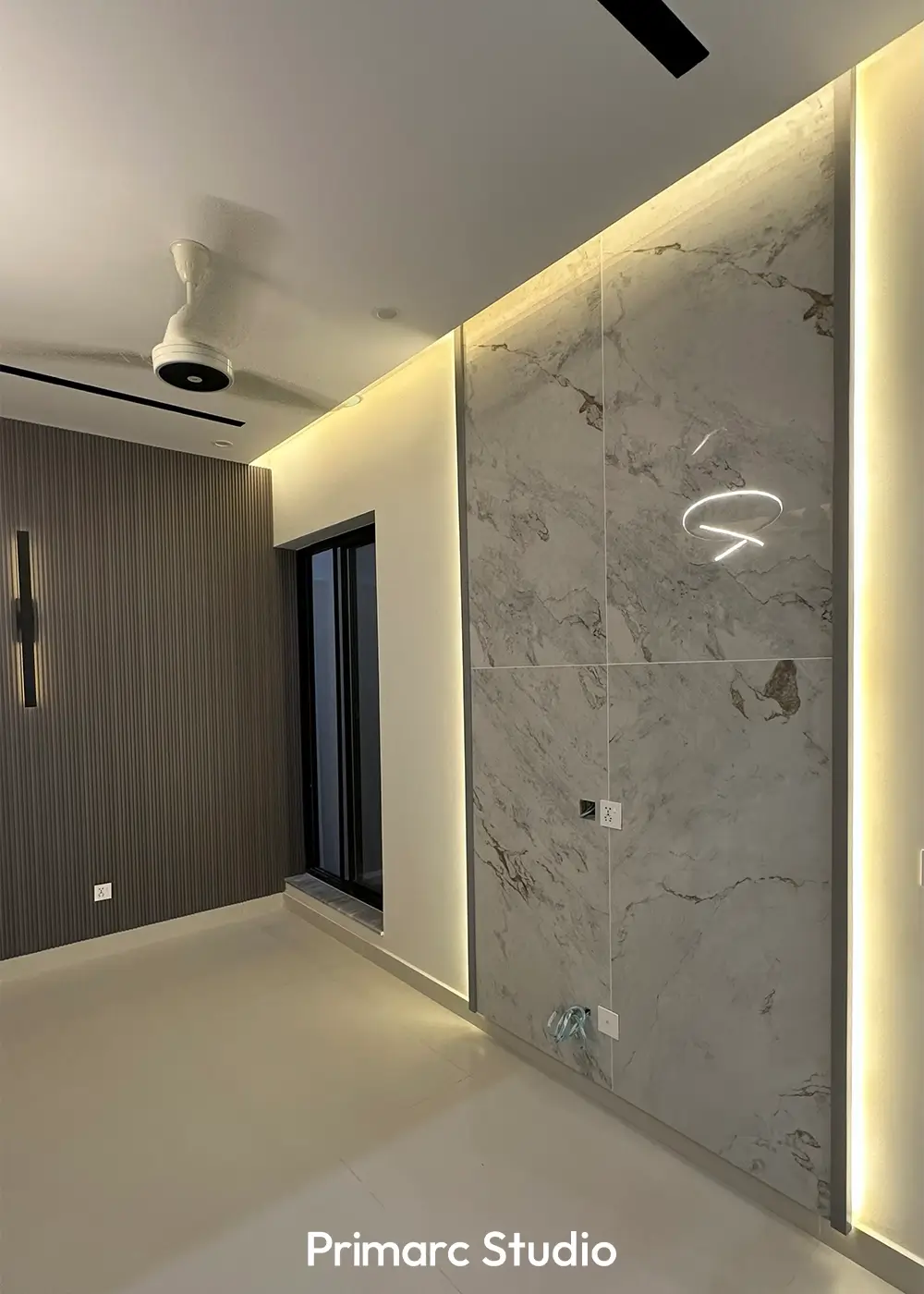Bedroom with marble feature wall, ambient lighting, and modern ceiling design in 10 marla house Gulberg Residencia Islamabad.