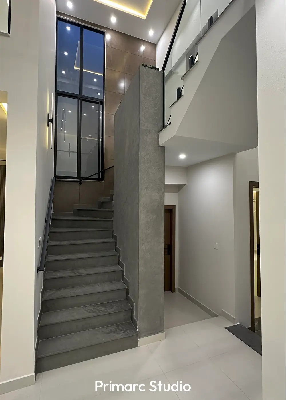 Elegant concrete staircase with glass railing in 10 marla modern house Gulberg Residencia Islamabad.