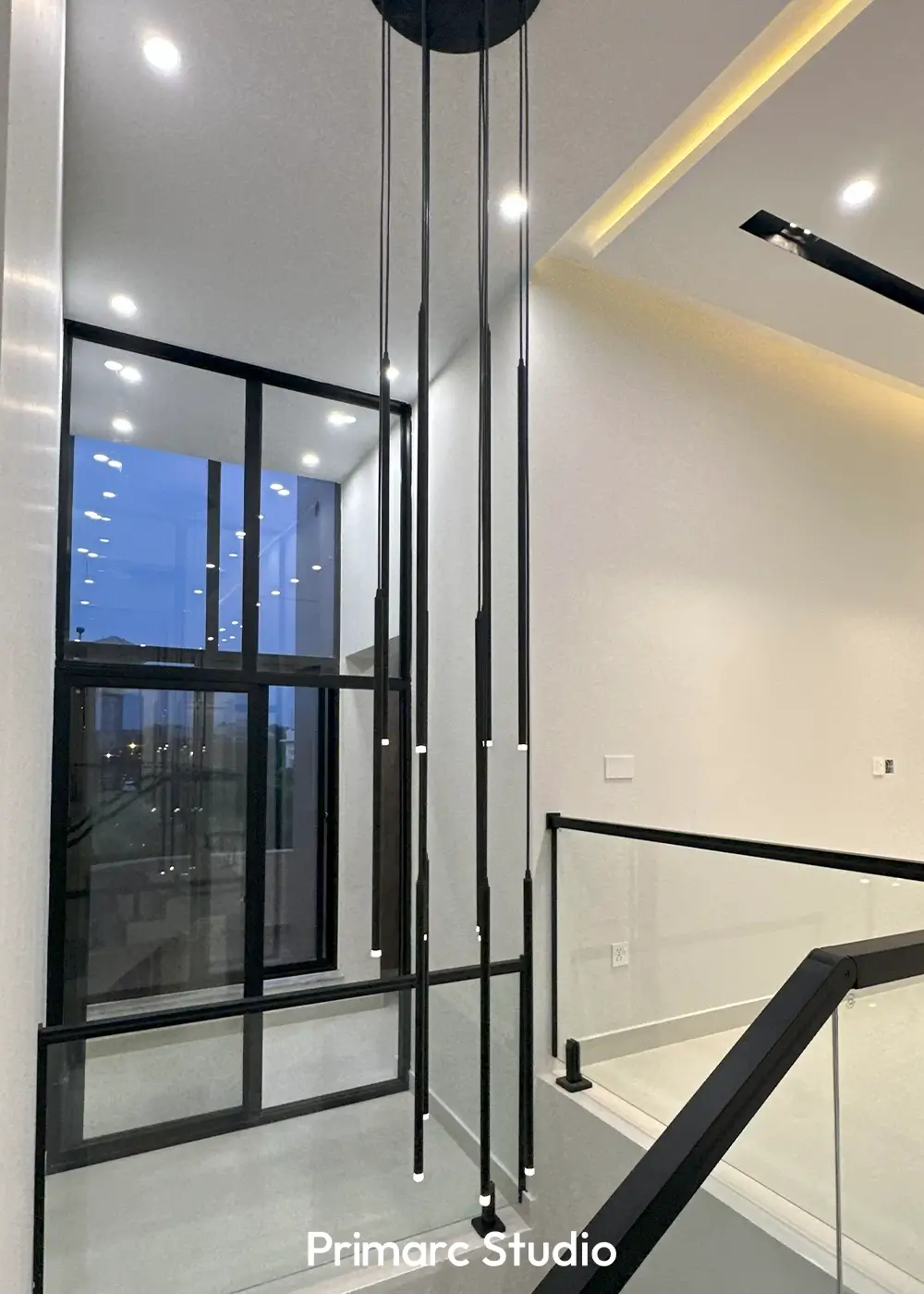 Vertical pendant lights in double height space of 10 marla modern home Gulberg Residencia Islamabad.