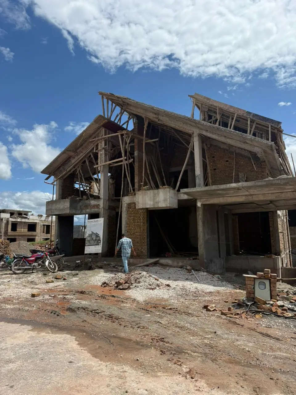 1 Kanal house under construction in Park View City Islamabad with exposed brickwork, concrete framework, and pitched roof structure.