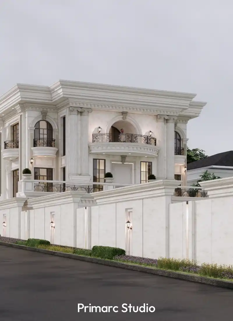 The white classical facade of a luxury villa in B-17, showcasing decorative boundary walls and arched window details.